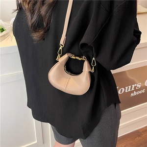 Mini beige half-moon pu leather crossbody bag with golden metal handle and shoulder strap