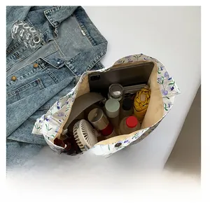 Top view of large floral canvas tote bag showing spacious interior with daily essentials