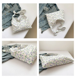 Detail view of floral canvas tote bag with purple flower patterns and wide straps