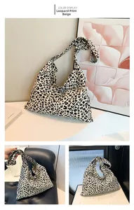 Detail of leopard print canvas tote bag with decorative knot and wide shoulder strap
