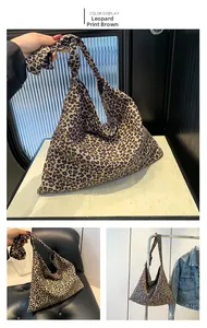 Detail of leopard print tote bag featuring a stylish knotted shoulder strap design