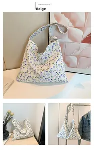 Detail of beige floral canvas tote bag showing purple pansy patterns and cotton texture