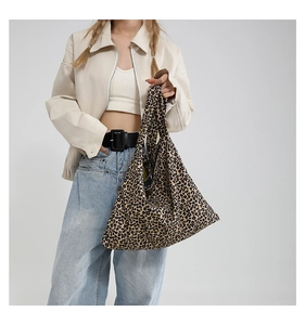 Fashionable leopard print tote bag styled with a beige leather jacket and jeans