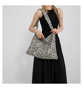 Detailed view of the large capacity leopard print tote bag styled on a female model