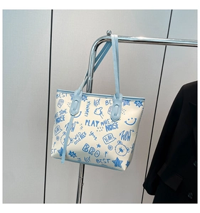 Vue détaillée de l'imprimé graffiti sur ce sac cabas en toile ivoire avec bordure bleue