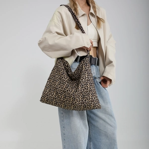 Large leopard print tote bag for women featuring canvas texture and wide shoulder straps