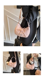 Detail of pink bow shoulder bag showing textured jacquard fabric and knotted handle