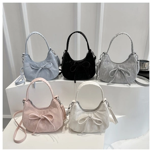 Detailed display of five crescent bow handbags in sky blue, black, grey, pink, and ivory