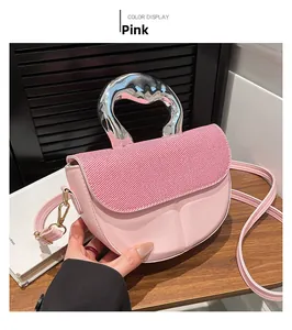 Detailed view of pink crossbody bag with unique fluid silver metal handle and texture