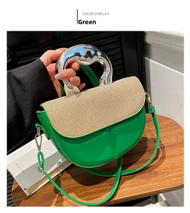 Detail of green saddle bag with woven texture lid and elegant silver metal handle