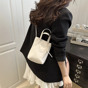 Minimalist cream white tote bag with dual handles and fashion bags text shown on model