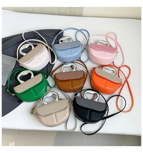 Matrix display of multi-color saddle bags with textured flaps and metallic handles