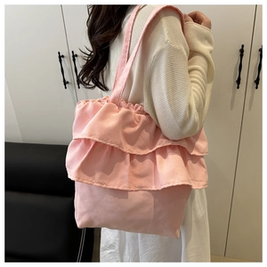 Close-up of pink tote bag featuring multi-layer ruffle design and soft canvas texture