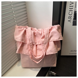Detailed close-up of pink ruffled canvas tote bag featuring sweet layered frill design