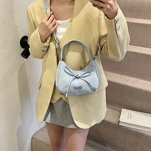 Light blue crescent hobo bag for women featuring a large bow and versatile strap
