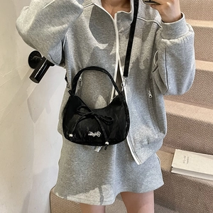 Women's black bow shoulder bag in Y2K style with adjustable strap and embroidery