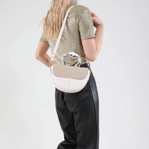 Minimalist cream saddle bag with woven texture lid and fluid silver metal handle on model