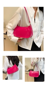 Detail of glossy rose pink patent leather shoulder bag with gold zipper and thin strap