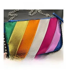 Close-up of rainbow striped textured leather bag with silver rivets and chain strap