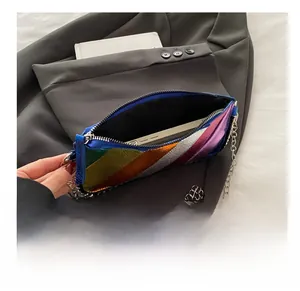 Internal capacity of rainbow striped chain crossbody bag showing smartphone storage
