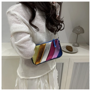 Detail of colorful metallic patchwork bag with silver bead studs and a chain strap