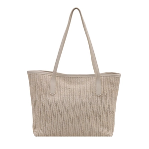 Beige woven straw tote bag with leather shoulder straps for beach vacations