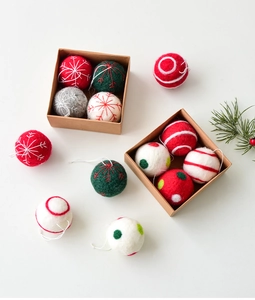 Detailed view of handmade wool felt Christmas balls with snowflake embroidery and gift box