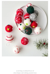 Detailed view of handcrafted wool felt Christmas balls with embroidered snowflakes and dots