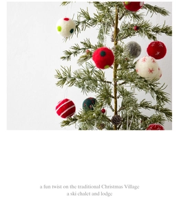 Close-up of wool felt snowflake balls hanging on a Christmas tree for holiday decor