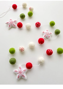 Close-up of wool felt Christmas garland with red and white stars and snowflakes