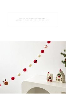 Detail of wool felt Christmas garland with reindeer balls and Santa belt ornaments