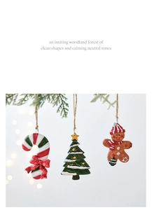 Detail of resin Christmas tree, gingerbread man, and candy cane hanging ornaments