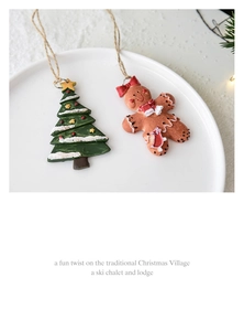 Detail of handcrafted resin Christmas ornaments featuring a tree and gingerbread figure