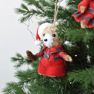 Handcrafted straw Christmas bear ornament in red plaid outfit hanging on a festive tree