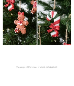 Detail of resin gingerbread man and candy cane ornaments hanging on a Christmas tree