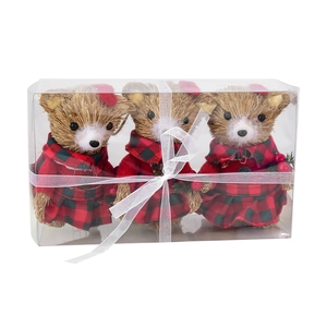 Three Christmas straw bear ornaments in red buffalo plaid outfits inside a gift box