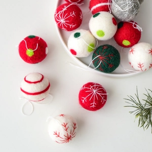 Handmade wool felt Christmas snowflake ornaments set with embroidery in festive colors