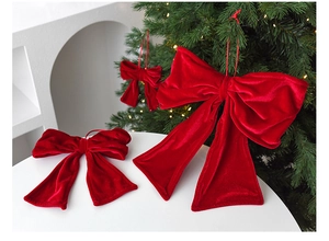 Close-up of red velvet Christmas bows showing soft texture and premium hanging cords