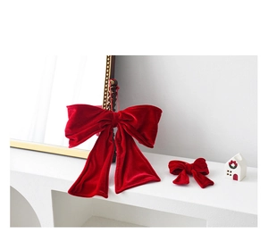 Detail of red velvet Christmas bows in large and small sizes for holiday tree decoration