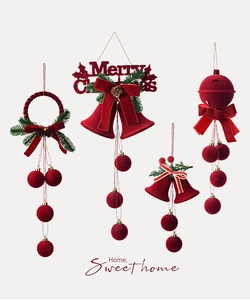 Detail of red flocked Christmas bell ornaments with pine needles and velvet bows