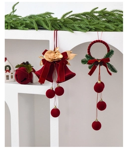 Close-up of red flocked Christmas bell ornament with gold flowers and pine needles