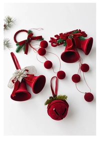 Detail of red velvet Christmas bells with pine cones and green needles decorations