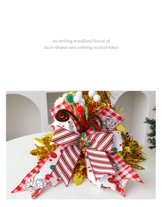 Detail of multi-layered Christmas bow topper with stripes, checkers and holly accents