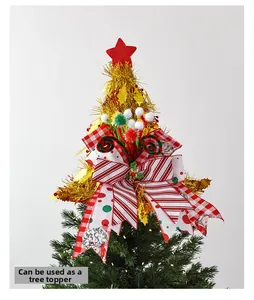 Detail of Christmas tree topper with red star, festive bow, and gold metallic textures