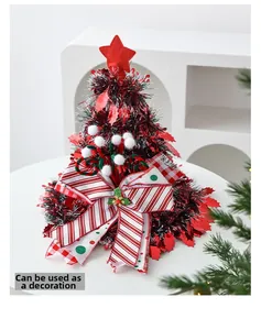 Close-up of a festive Christmas tree topper ornament with a red star and striped bow