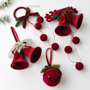 Red flocked Christmas bell ornaments with Merry Christmas text and faux pine cones