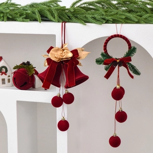 Christmas velvet bell and wreath ornaments with gold flowers on a white display