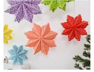 Close-up of multicolored 3D paper star lanterns with intricate cutout patterns