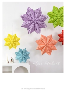 Close-up of colorful paper star pendants with hollow-out patterns for holiday decor