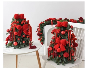 Mini tabletop Christmas tree set with red velvet bows and matching festive garlands